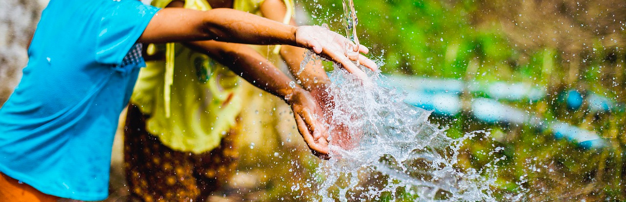 Kids playing with the water hose